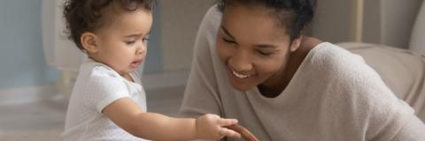 A female in home child care provider with little boy. 