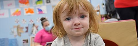 Happy red haired girl in quality child care. 