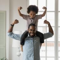 Father and son showing how strong they are.