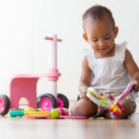 portrait of little african american little girl sitting on the floor and playing - black people 