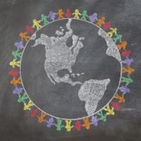 a hand drawn chalkboard shows multi-racial people holding hands around the world to show care for the earth, peace, and unity 