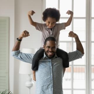 Father and son showing how strong they are.