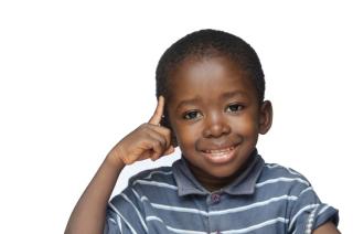 Little boy pointing a his head. 