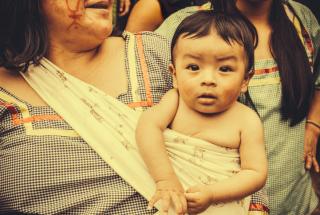 Baby in a sling with mom in Amazonia. 