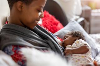 Mom breastfeeding her daughter. 