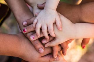 A family's hands stacked on top of each other. 