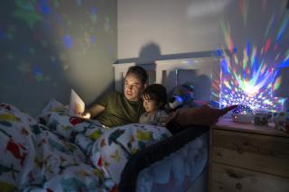 Dad reading a bedtime story to his son.