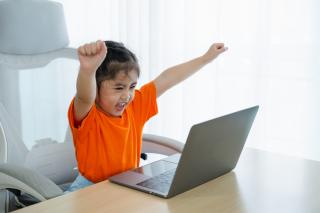 Little girl working at a computer. 