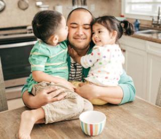 Kids hugging a father 