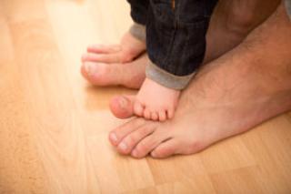 Boys to Men - baby feet on adult feet 