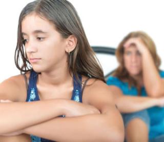 worried and thoughtful teenage girl with her mother at home 