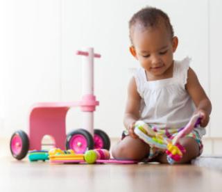 portrait of little african american little girl sitting on the floor and playing - black people 