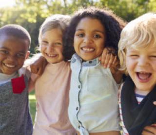 Four kids hanging out together in the garden 