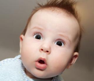 cute 4 months old baby making a funny surprised face 