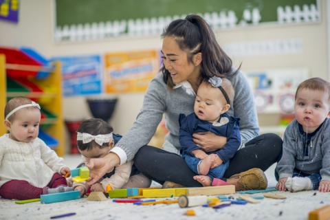 Teacher and Child Playing with Blocks