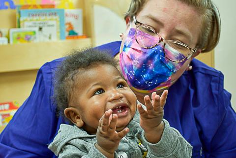 Happy baby with child care provider.